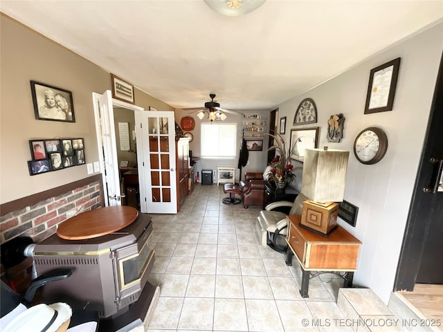 interior space with a ceiling fan and light tile patterned flooring