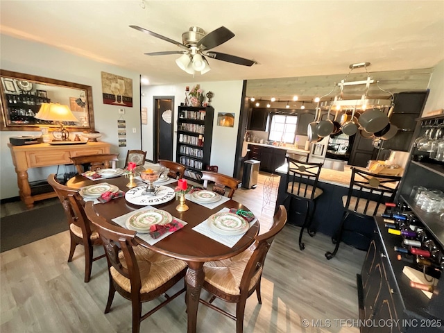 dining space featuring ceiling fan and light wood finished floors