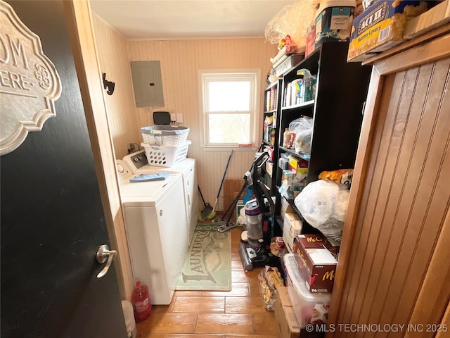 clothes washing area featuring laundry area, washing machine and dryer, and electric panel