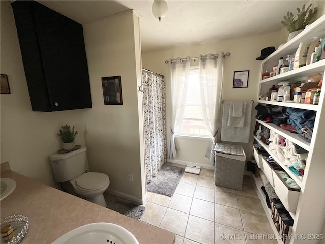 bathroom with toilet, tile patterned floors, vanity, baseboards, and a shower with curtain