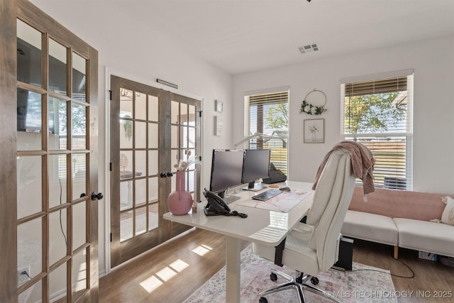 office area with french doors, visible vents, and wood finished floors