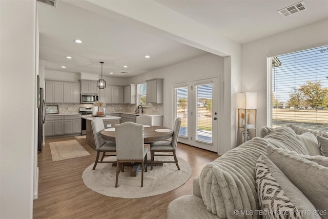 dining room with visible vents, wood finished floors, and recessed lighting