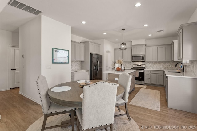 dining area featuring recessed lighting, visible vents, and light wood-style floors