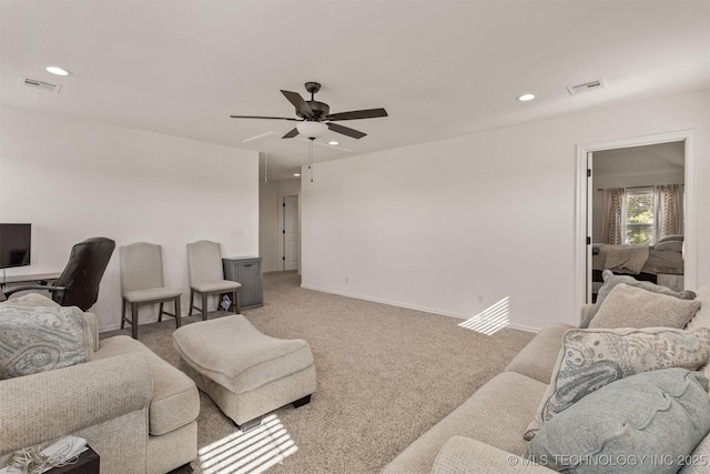 living area with carpet flooring, visible vents, and recessed lighting