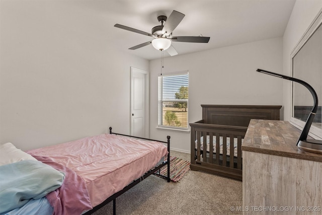 bedroom featuring a ceiling fan, carpet flooring, and baseboards