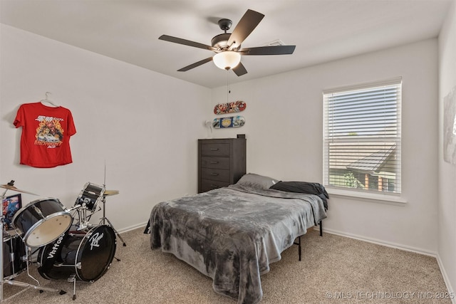 bedroom featuring carpet flooring, a ceiling fan, and baseboards