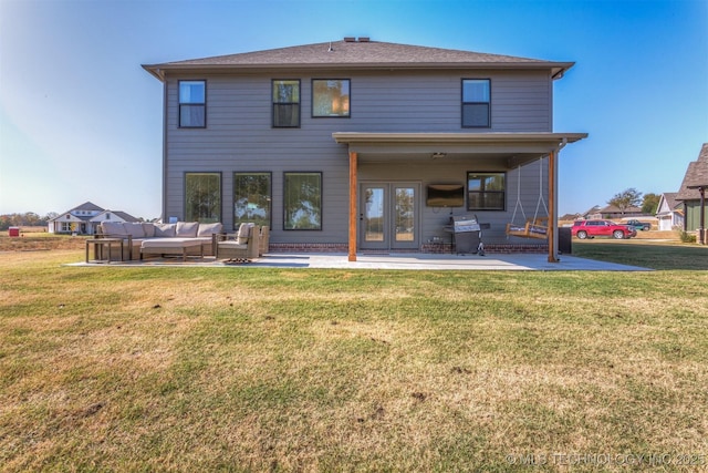 back of house with an outdoor living space, a lawn, and a patio