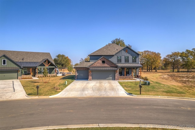 view of front of home featuring an attached garage, concrete driveway, and a front yard