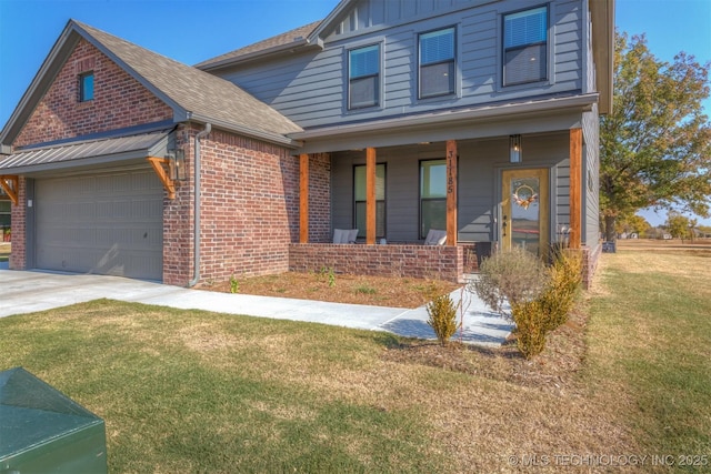 view of front of home featuring a porch, an attached garage, brick siding, a front lawn, and board and batten siding