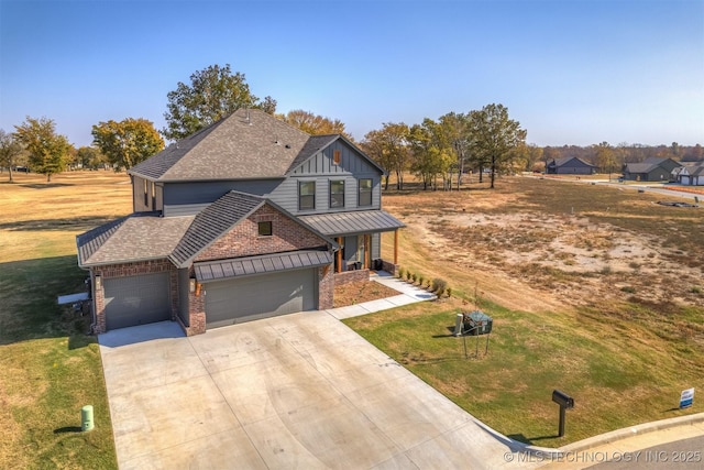 view of front facade with driveway, a garage, a standing seam roof, a front lawn, and board and batten siding