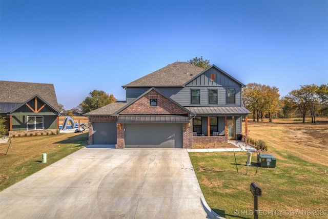 view of front of home featuring a garage, brick siding, board and batten siding, and a front lawn