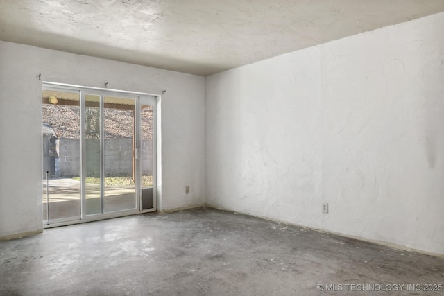 empty room with unfinished concrete flooring