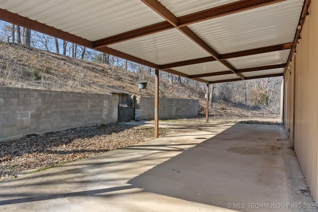 view of patio / terrace featuring fence and a carport