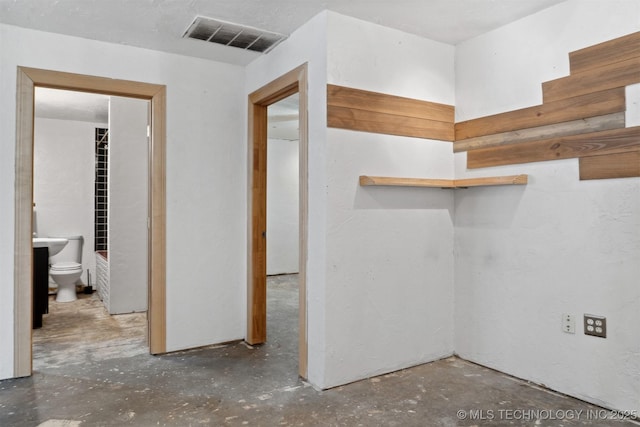 interior space with visible vents and unfinished concrete flooring