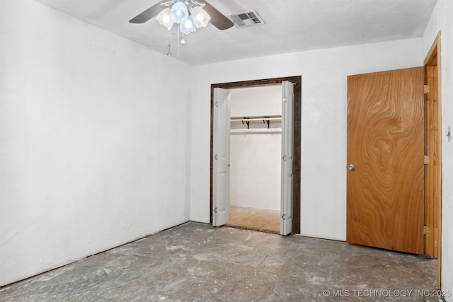 unfurnished bedroom featuring a closet, ceiling fan, concrete flooring, and visible vents