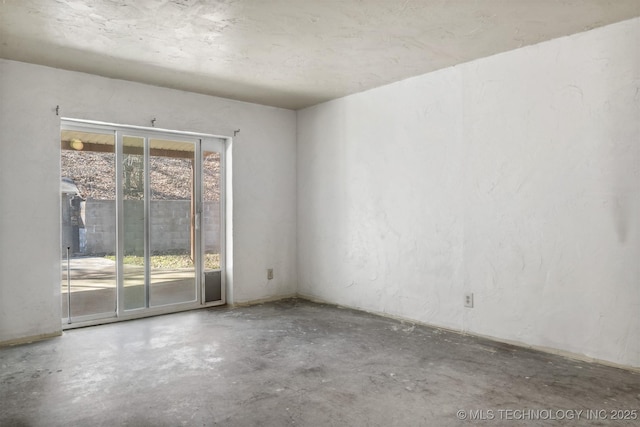 unfurnished room featuring unfinished concrete flooring