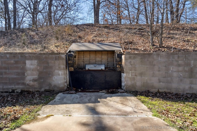 view of outdoor structure with fence private yard and a gate