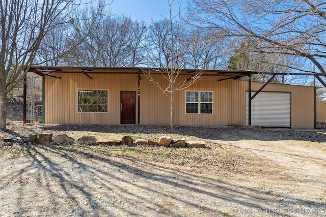 single story home with an outdoor structure and a garage