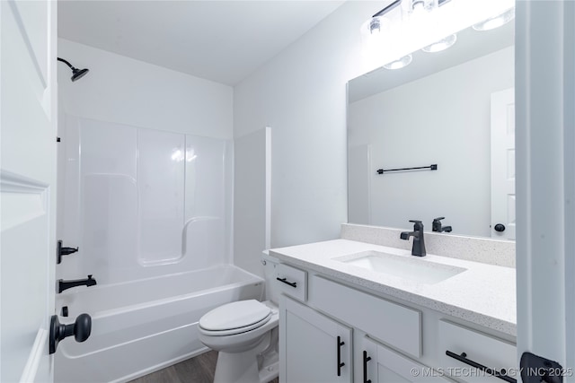 bathroom featuring wood finished floors, vanity, toilet, and bathing tub / shower combination