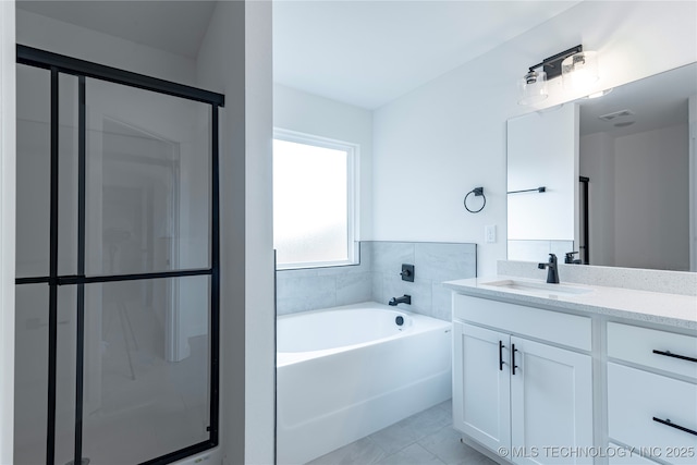 bathroom featuring visible vents, a garden tub, vanity, and a shower stall