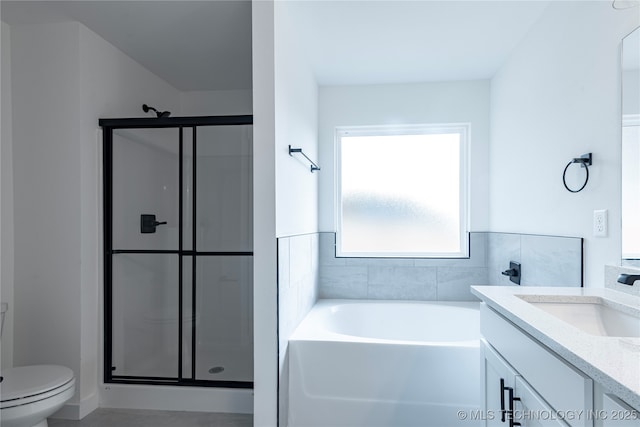 bathroom featuring a garden tub, toilet, a shower stall, and vanity