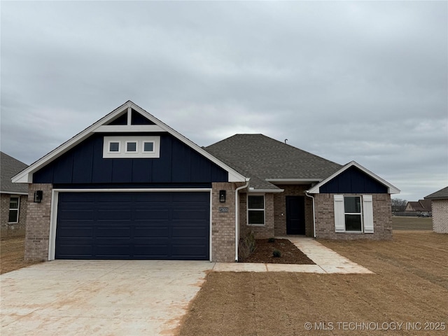 view of front of house with driveway, brick siding, board and batten siding, and roof with shingles