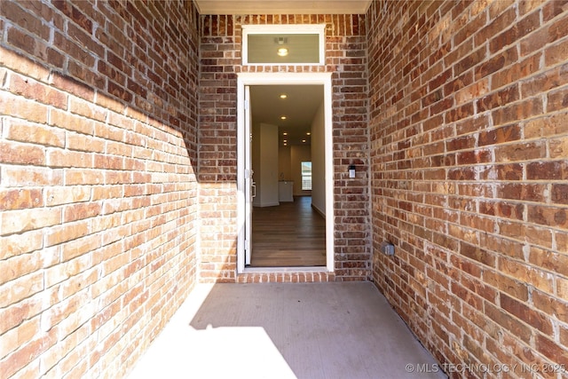 entrance to property with brick siding