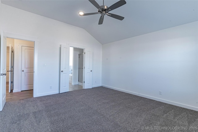 unfurnished bedroom featuring connected bathroom, carpet, vaulted ceiling, and baseboards