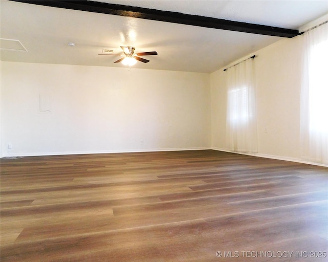 unfurnished room with beamed ceiling, baseboards, wood finished floors, and a ceiling fan