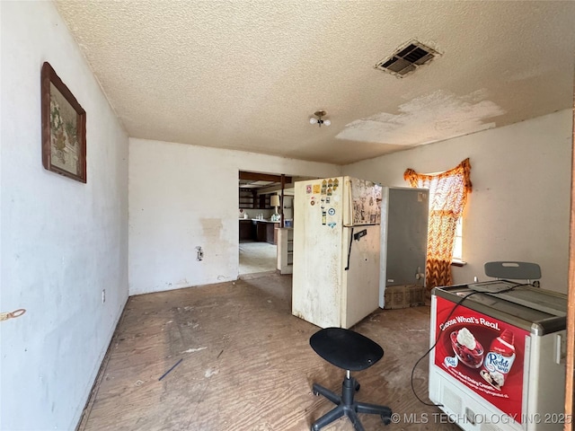 kitchen featuring visible vents and a textured ceiling