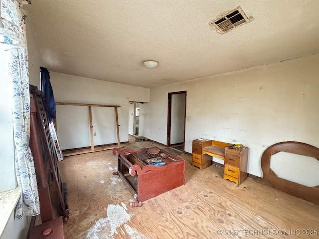 bedroom with visible vents and a textured ceiling