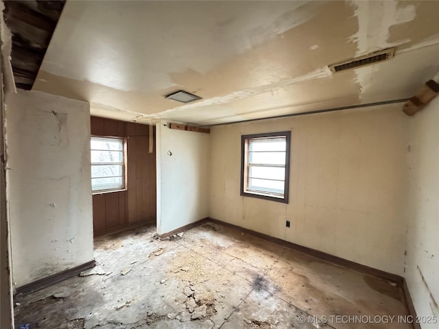 empty room featuring visible vents and baseboards