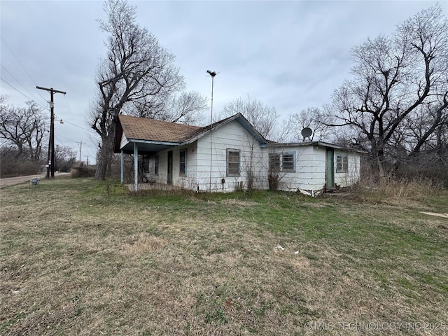 rear view of property with a lawn