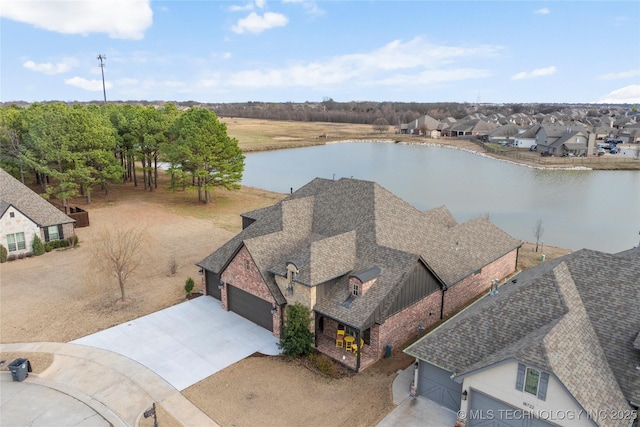 birds eye view of property featuring a water view and a residential view