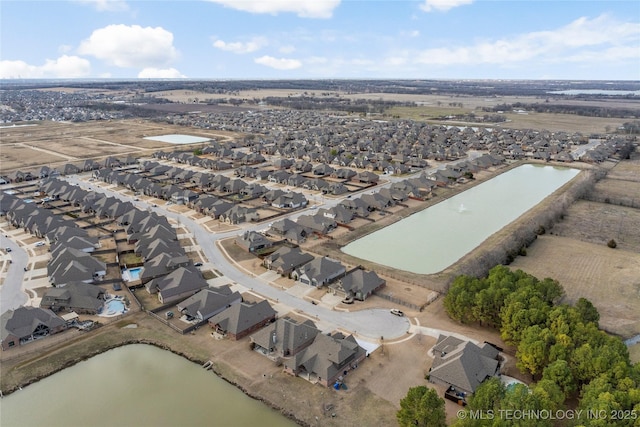 drone / aerial view with a water view and a residential view