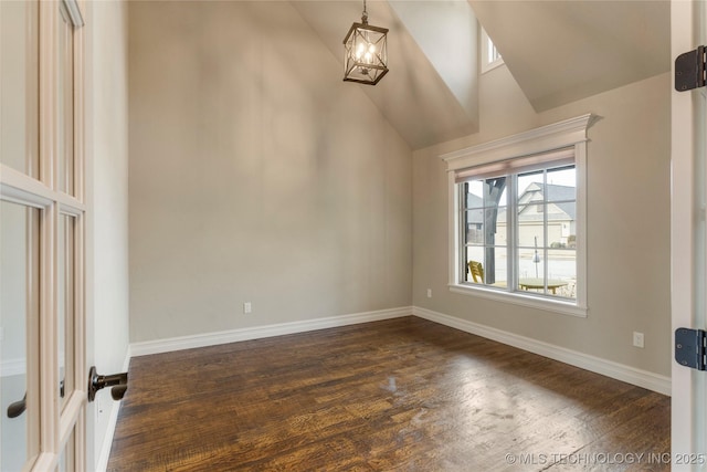 unfurnished room with high vaulted ceiling, baseboards, and dark wood-style flooring