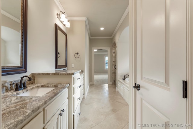 bathroom with ornamental molding, two vanities, a sink, and a bath