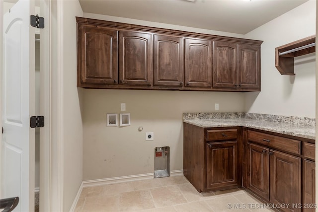 clothes washing area with hookup for a washing machine, cabinet space, hookup for an electric dryer, gas dryer hookup, and baseboards