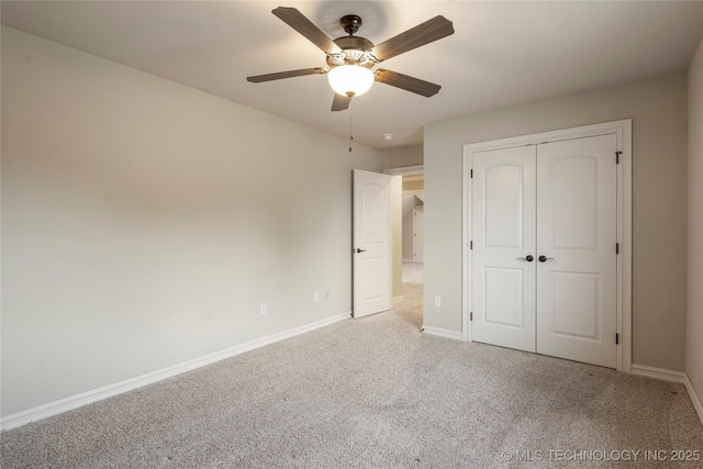 unfurnished bedroom featuring a ceiling fan, a closet, baseboards, and carpet flooring