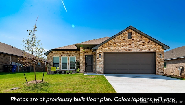 view of front of property featuring a garage, driveway, a front lawn, and brick siding