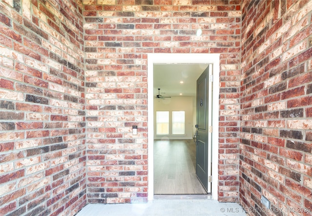 doorway to property featuring brick siding