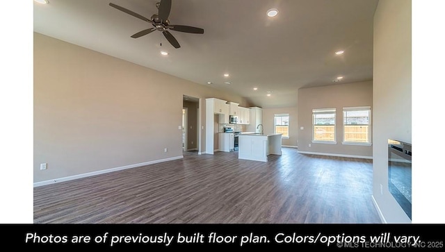 unfurnished living room with recessed lighting, baseboards, and wood finished floors