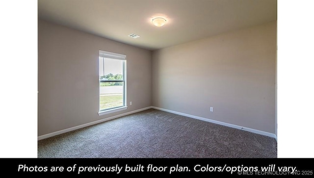 carpeted spare room featuring visible vents and baseboards