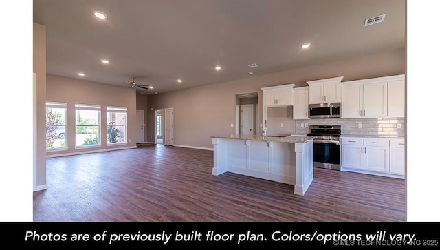 kitchen with stainless steel appliances, tasteful backsplash, visible vents, open floor plan, and white cabinets