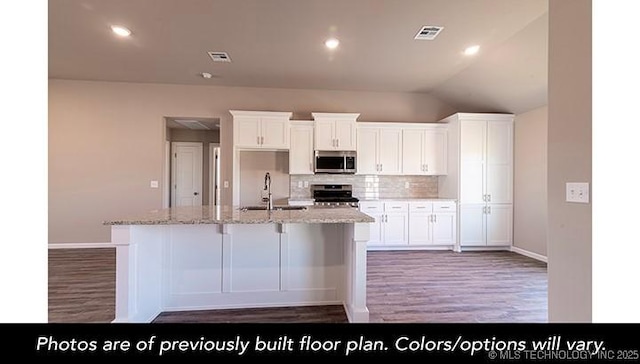 kitchen with visible vents, white cabinets, appliances with stainless steel finishes, tasteful backsplash, and a center island with sink