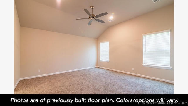 spare room with ceiling fan, carpet flooring, visible vents, baseboards, and vaulted ceiling