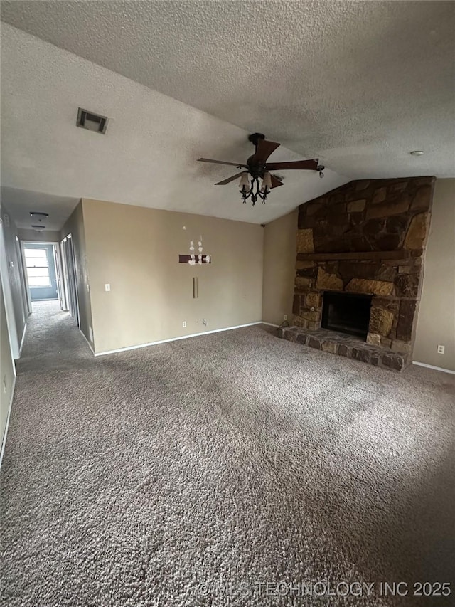 unfurnished living room featuring lofted ceiling, a fireplace, visible vents, and carpet