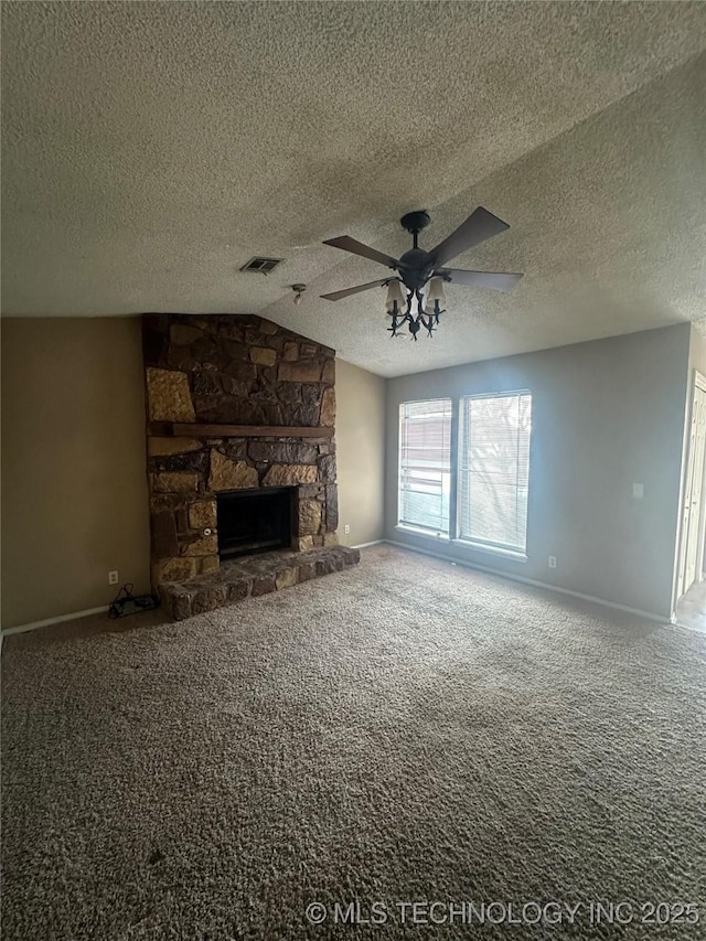 unfurnished living room featuring visible vents, lofted ceiling, ceiling fan, carpet floors, and a fireplace