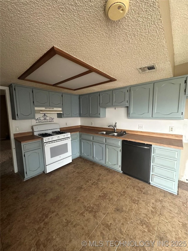 kitchen with under cabinet range hood, white range with gas stovetop, a sink, visible vents, and dishwasher