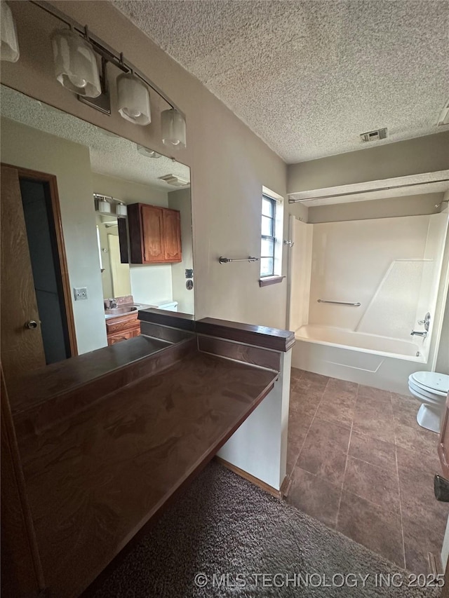 bathroom featuring visible vents, toilet, tile patterned flooring, a textured ceiling, and vanity